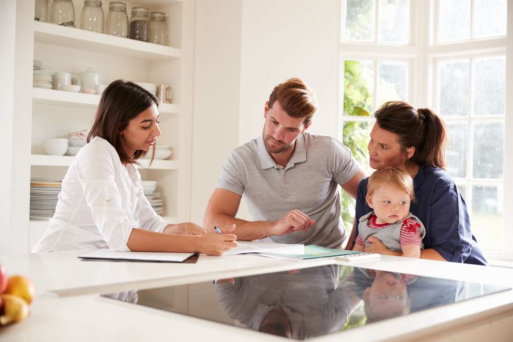 Family,With,Baby,Meeting,Financial,Advisor,At,Home